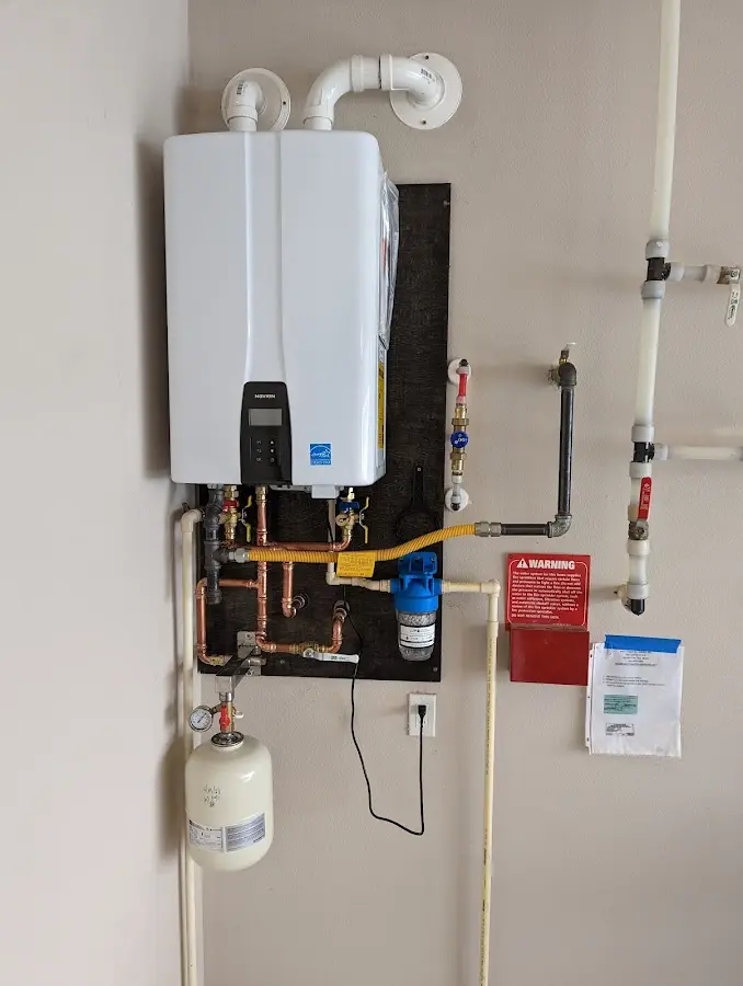 Professional plumber installing copper piping in a Elberton home